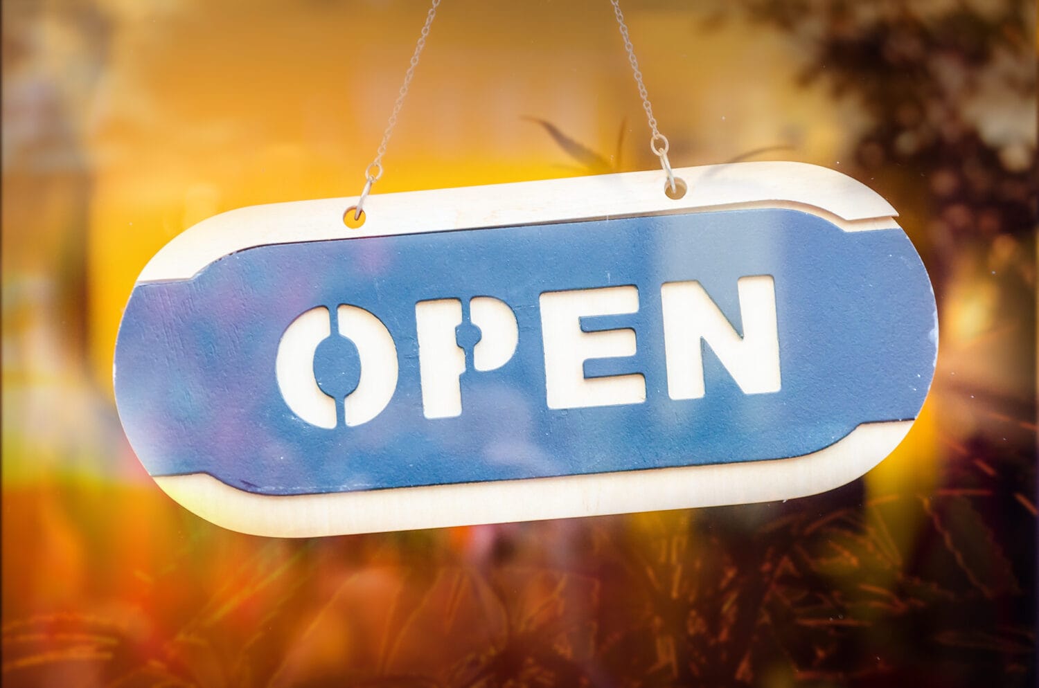 Wood open sign at the mirror door of store